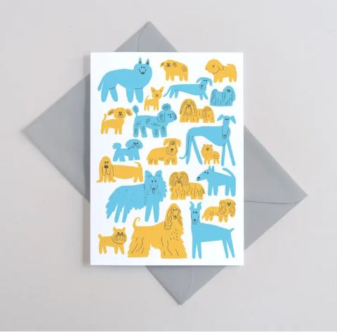The Woof Greeting Card by Blue Dog Posters features playful blue and yellow cartoon dogs on white, is FSC certified and plastic free, and comes with a light gray envelope.