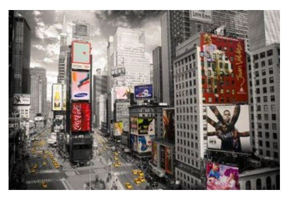 A black-and-white photo of a bustling cityscape with numerous tall buildings adorned with vibrant, colorful advertisements. Yellow taxi cabs are seen moving through the wide streets, capturing an overall lively urban atmosphere perfect for a NAT 007 Times Square.