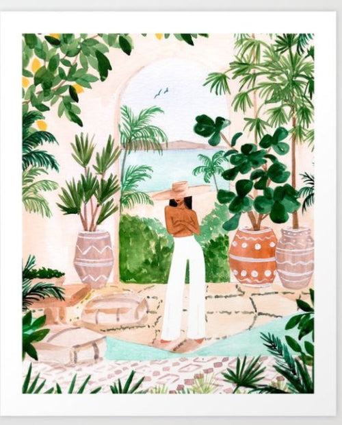 The GAL42 Art Print "Peaceful Morocco II" by Sabina Fenn features a person in a brown top, white pants, and a wide-brimmed hat amidst lush garden greenery and potted plants. Two birds soar against a light blue sky, beautifully capturing nature's essence.
