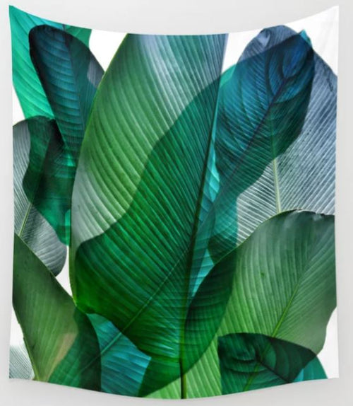 A Blue Dog Posters Palm Leaf Jungle Art Textile Sml featuring large, overlapping tropical leaves in various shades of green and blue with a soft, diffused background. Ideal for wall tapestries, the leaves have prominent veins and create a vibrant, layered effect.
