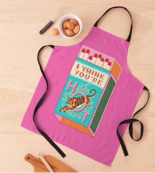 The "I Think You Are Hot Apron" by Blue Dog Posters, part of our Homewares Collection, showcases a vibrant matchbox pattern with striking text that reads "I THINK YOU'RE HOT," accompanied by a powerful tiger illustration. Crafted from 100% polyester, the design also depicts eggs and a wooden spoon on a light wooden background. The apron is in pink color.
