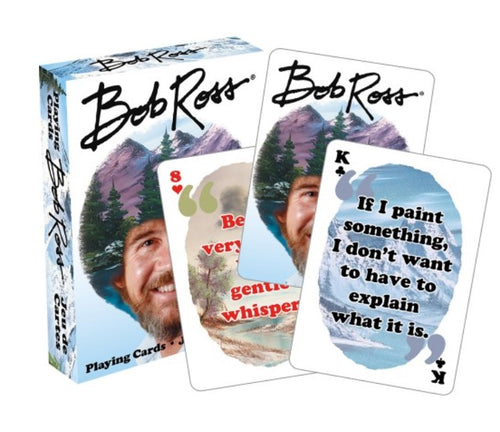 A box of Bob Ross Version 2 Playing Cards is shown with the box and three cards visible. The box, perfect for Cool Gifts, displays Bob Ross’s face and name. Two cards have images and Bob Ross quotes that bring laughs, while the third is a standard card showing an 8 of hearts.