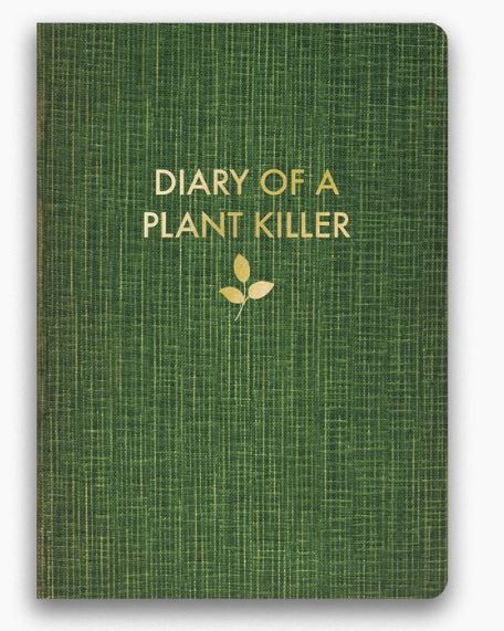 A green fabric-covered "Diary of a Plant Killer Journal" by Blue Dog Posters, featuring the title in gold uppercase letters on its foil cover. Below the title, a charming illustration of three golden leaves adds a touch of elegance.