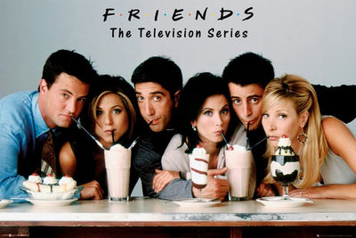 The image shows six people sitting together, each with a straw in a milkshake, leaning towards the center of the table. Above them is text that reads "FRIENDS The Television Series." This fun, casual scene among friends would make a great addition to any Friends Milkshake MTV 295 collection.
