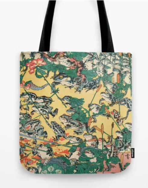 The Tote Bag 40x40cm Frog Battle by Blue Dog Posters features black straps and a detailed, intricate design showcasing frogs engaged in various activities. The colorful artwork—featuring shades of green, yellow, and red—resembles a traditional Japanese illustration.