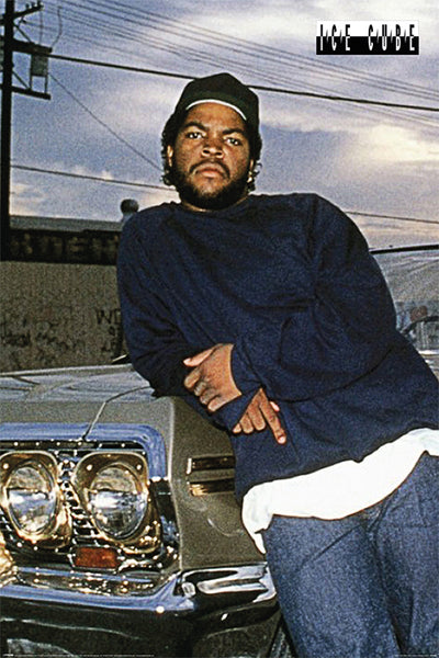 A man in a dark blue sweatshirt and jeans leans against the front of a classic car, with a serious expression and an urban setting in the background. The text "ICE CUBE" appears in the top right corner, making this MUS 146 "Ice Cube Impala" print a perfect addition to any Hip Hop Poster collection.