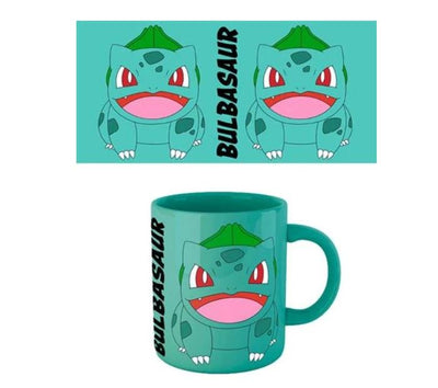 Presenting the Pokemon Bulbasaur Coloured Mug by Blue Dog Posters: a teal mug adorned with an illustration of the Pokémon Bulbasaur. The design showcases Bulbasaur's face and upper body with an open mouth, both on the officially licensed mug and in the matching graphic above it, complemented by the name "BULBASAUR" written vertically beside the image.