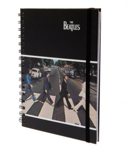 The Blue Dog Posters' The Beatles Abbey Road A5 Spiral Notebook is a black notebook adorned with an iconic photograph of The Beatles crossing a zebra crossing, inspired by their "Abbey Road" album cover. As part of our Premium Notebooks in the Stationery Gifts Collection, it features "The Beatles" in white text at the top and includes a black elastic band for closure.