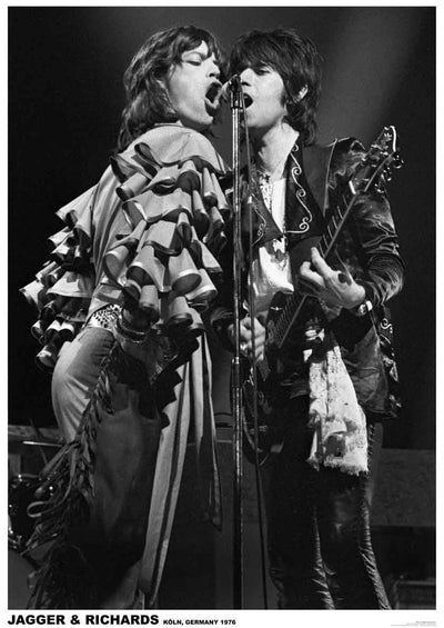 Two musicians perform on stage in this black-and-white image. The singer on the left passionately sings into a microphone, while the guitarist on the right plays and sings into the same microphone. They are both wearing rock-style outfits. Text at the bottom reads "Jagger & Richards Koln, Germany 1976." This premium 150gsm gloss paper rock poster "Rolling Stones" by MUS 202 is a must-have for any music collection.