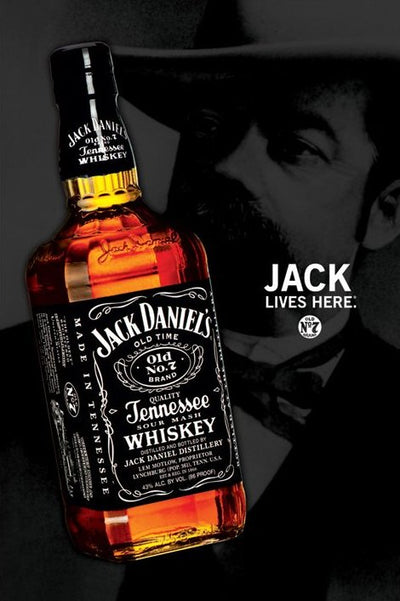 A bottle of Jack Daniels lies on its side in the foreground, with a grayscale portrait of a mustached, hat-wearing man behind it. "JACK LIVES HERE." appears in bold. Printed by ALT on premium 150gsm gloss paper.